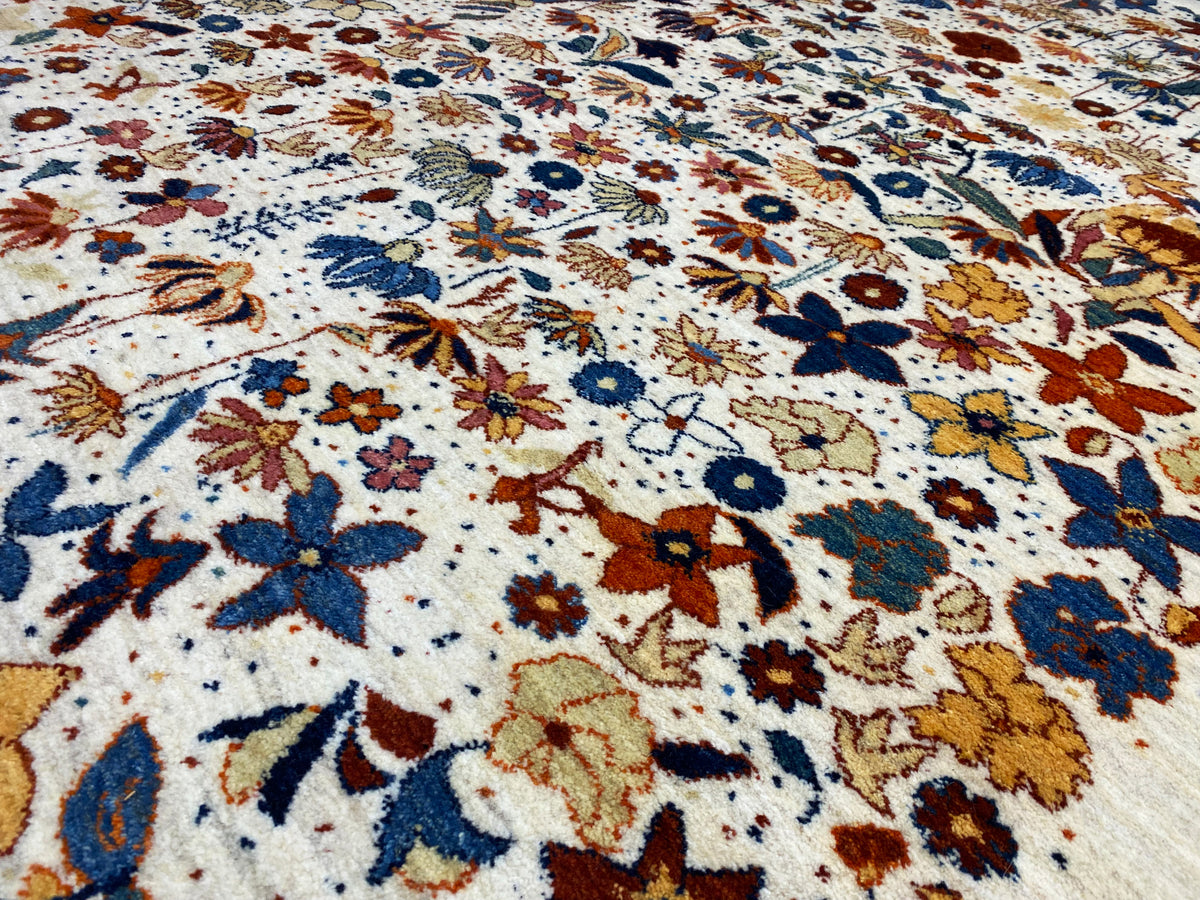 Close-up of the carpet pattern: many small flowers in blue, yellow, red, and brown