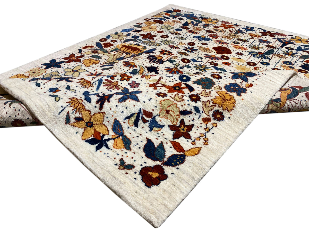 Carpet in three-quarter view: multicolored floral pattern on a light-colored rectangular base