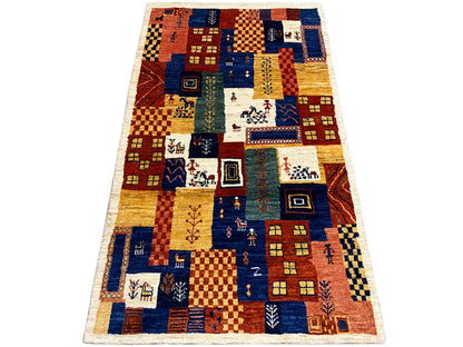 Gabbeh-Luri rug 158x86 cm in a mix of blue, ochre, red, and cream with ornamental corners