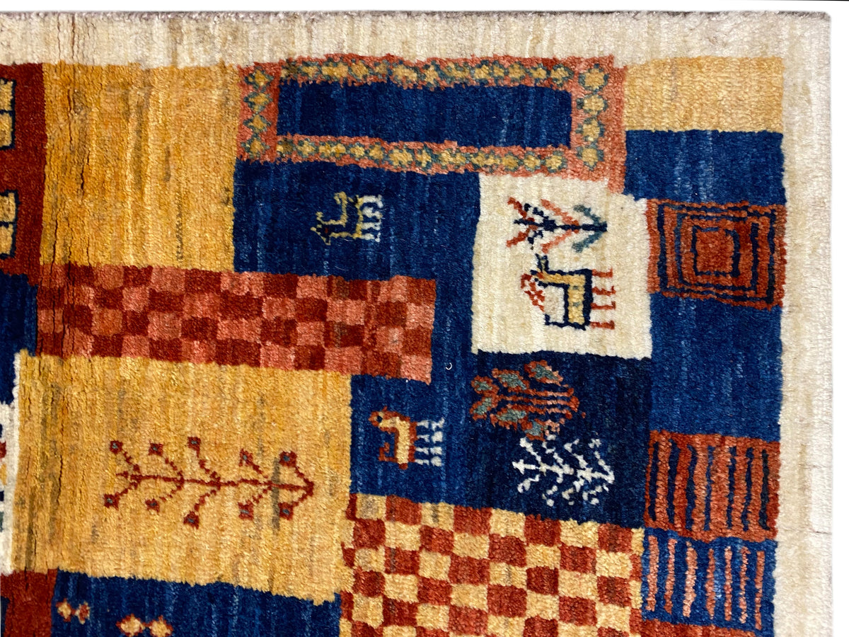 Close-up Gabbeh-Luri rug 158x86 cm: dense pile, blue, ochre, and red tones in the pattern