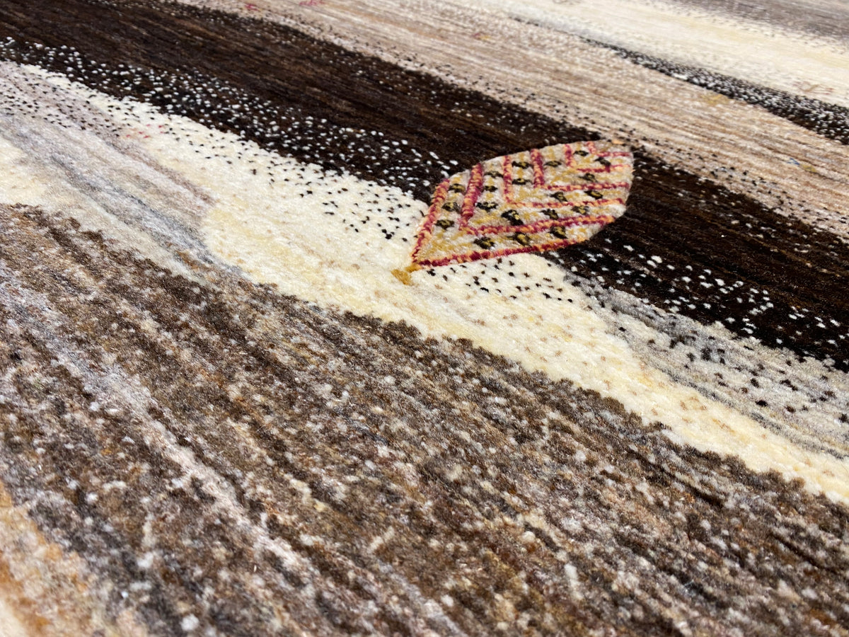 Close-up: textured carpet fiber with patterned motifs in beige and dark tones