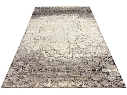 Rectangular rug with a two-tone abstract pattern in beige and gray