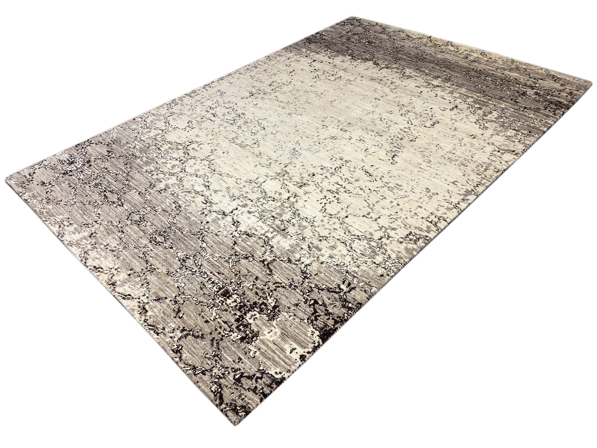 Rug with a light beige background and dark gray spots and ornamental lines, diagonal