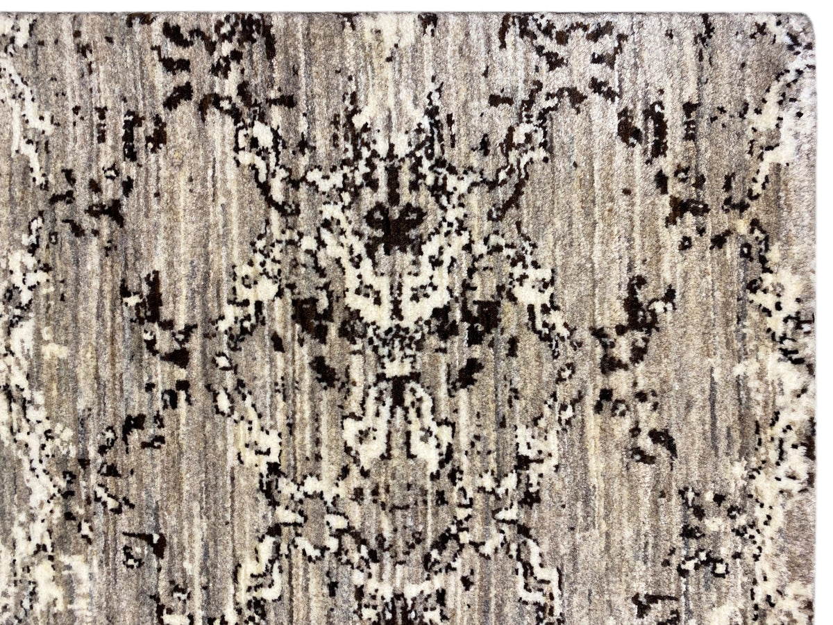 Close-up: light beige carpet with black and gray spots, vertical texture