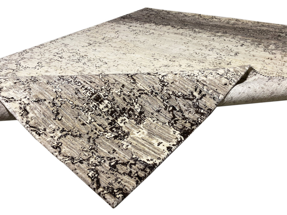 Rug laid diagonally with a light beige background and dark gray ornamental lines