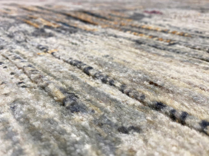 Gabbeh-Luri rug close-up: light gray texture with dark and golden stripes