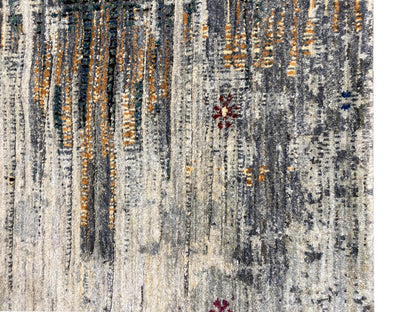 Gabbeh-Luri rug close-up: light gray flatweave with orange lines and spots