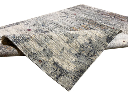 Gabbeh-Luri rug detail: light patterned area with rolled-up edge