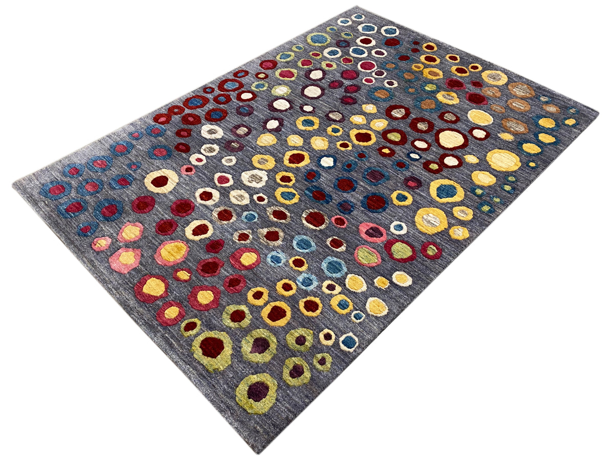 Gabbeh Luri rug in diagonal view: gray background with colorful circle and ring motifs