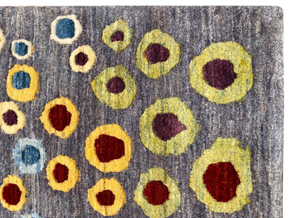 Close-up of a Gabbeh-Luri rug: gray wool with yellow, red, and blue circular rings