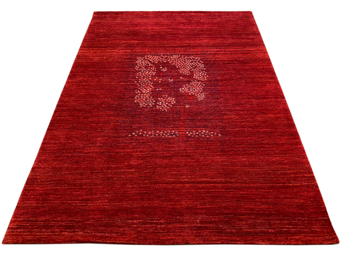 Reddish-brown rug with a central medallion and a surrounding mottled pile area