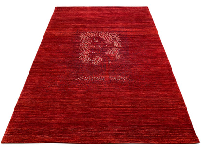 Reddish-brown rug with a central medallion and a surrounding mottled pile area