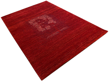 Reddish-brown carpet viewed diagonally with a medallion pattern and mottled pile texture
