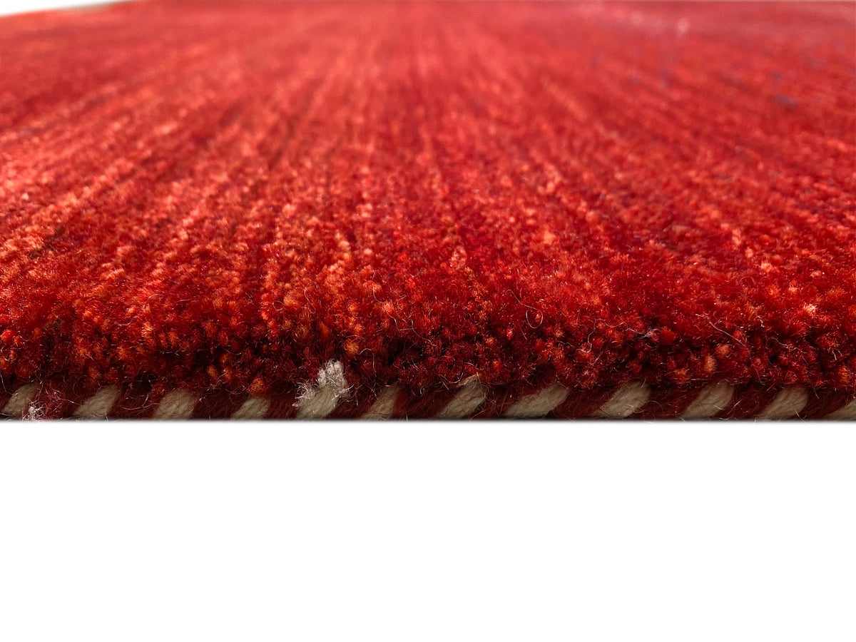 Close-up of the carpet surface: reddish-brown pile with visible, patterned woven threads