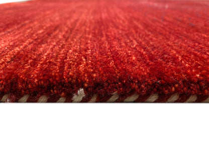 Close-up of the carpet surface: reddish-brown pile with visible, patterned woven threads