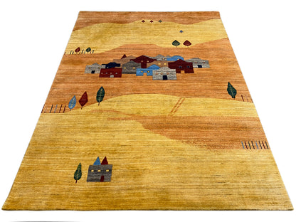 Rug with a border at the top and a central village motif in shades of blue and red