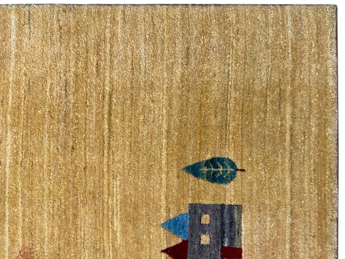 Carpet surface in golden yellow with short pile and a small house motif in blue