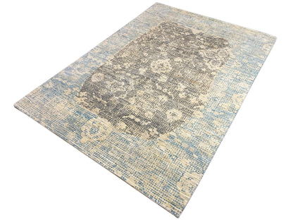 Carpet from above: blue-gray gradient with a gray ornamental pattern
