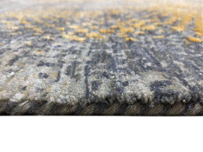 Close-up of a Gabbeh-Luri rug: pile surface with gray and golden-yellow patterned sections