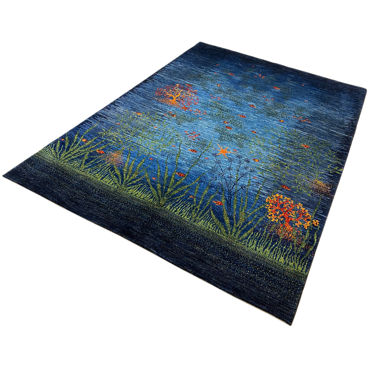 Carpet in angled view: blue base field with green plant lines and orange dots