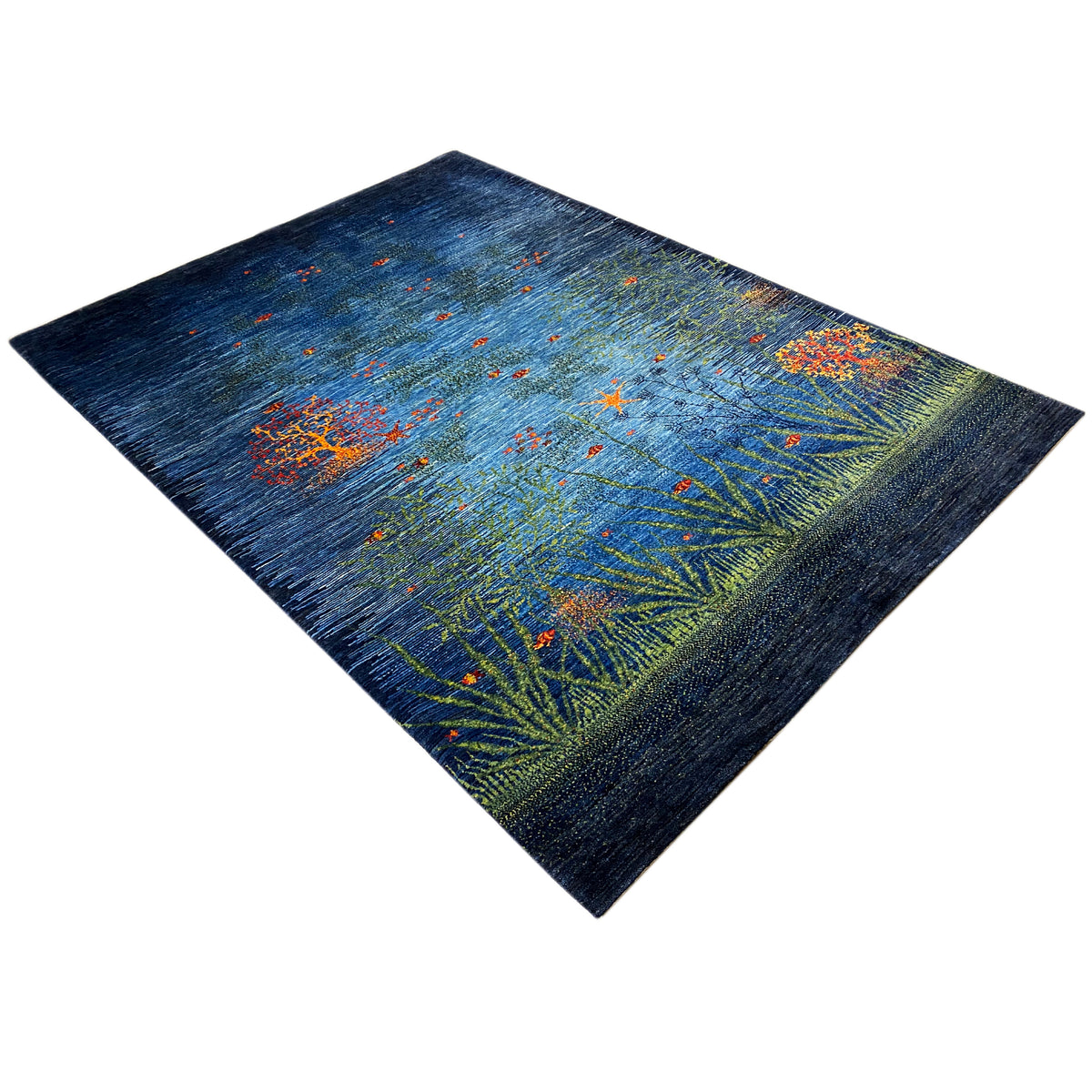 Top view of a carpet: dark blue with yellow-green patterns and orange flowers