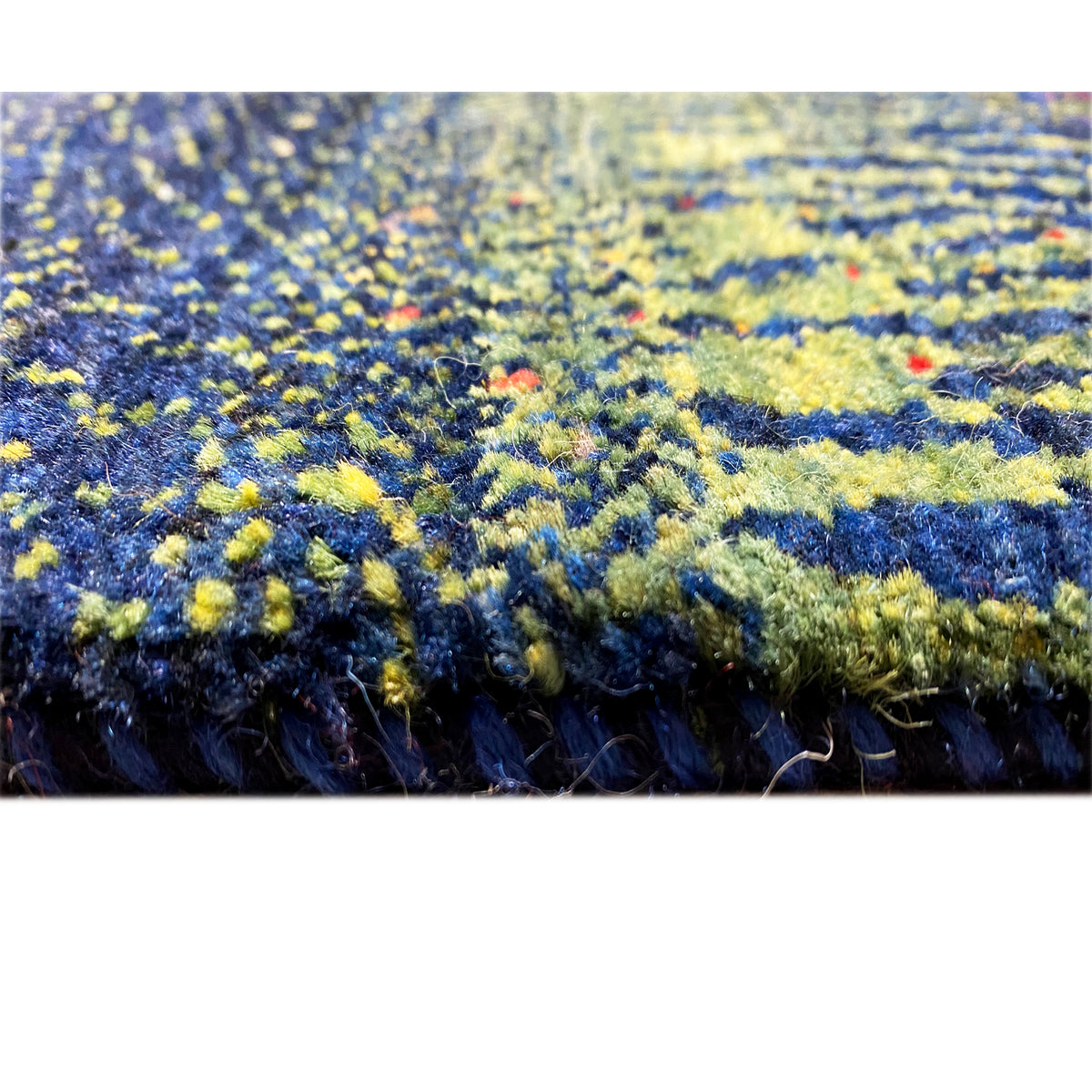 Carpet border with multicolored plant motifs in blue, yellow, and green