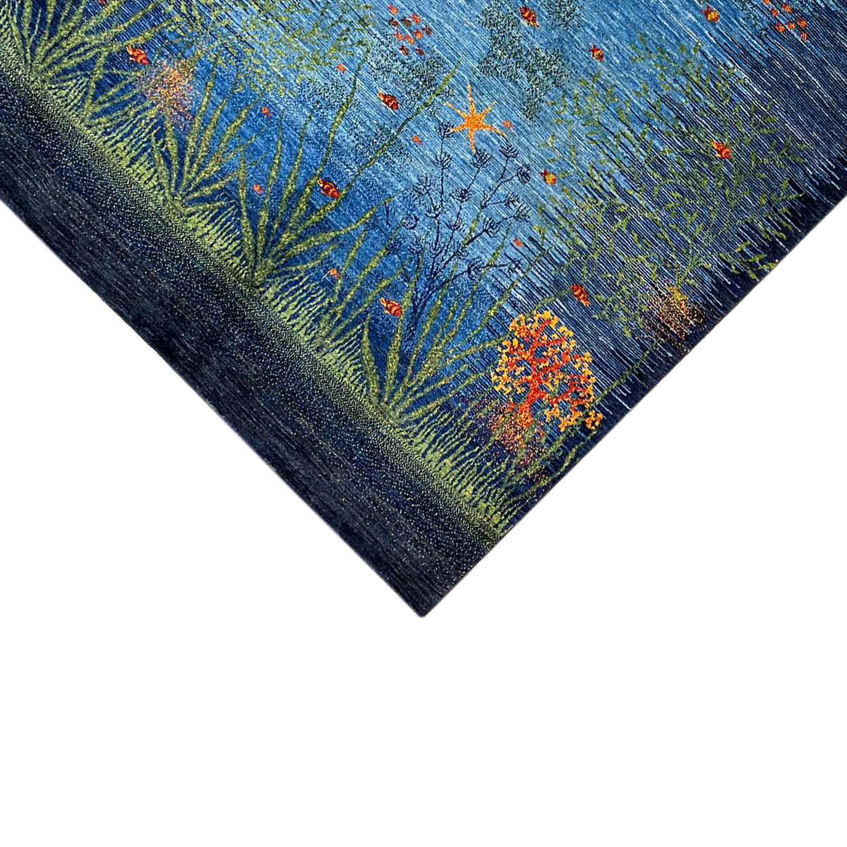 Rug near the edge: blue-green with an orange blossom and fine plant lines