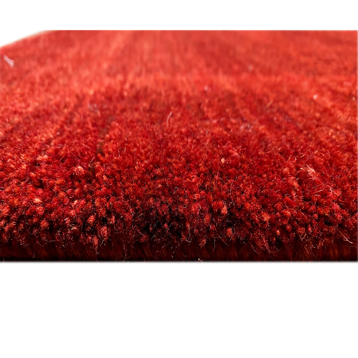 Red Gabbeh Luri rug with dense pile, close-up of the surface