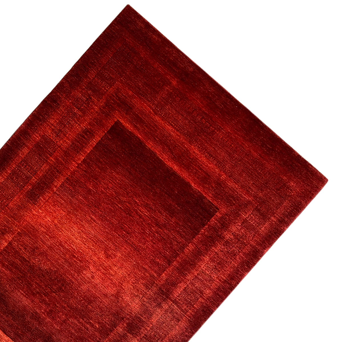 Red Gabbeh Luri rug: close-up of the diagonal border pattern
