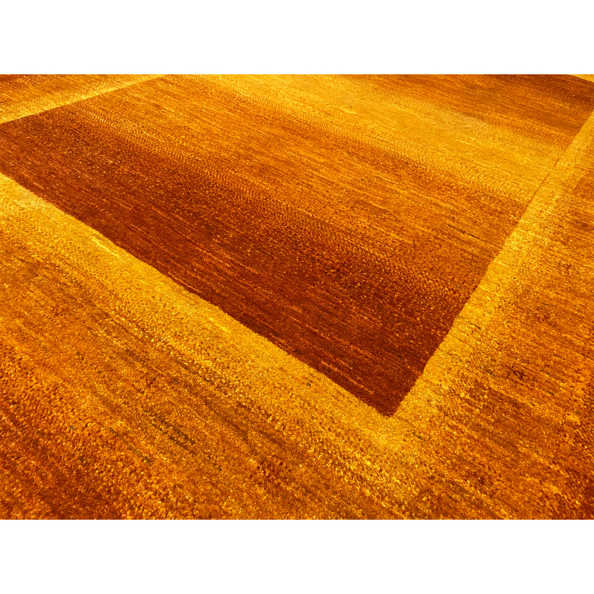Carpet surface with a fine pile texture and a gold-rust-colored field