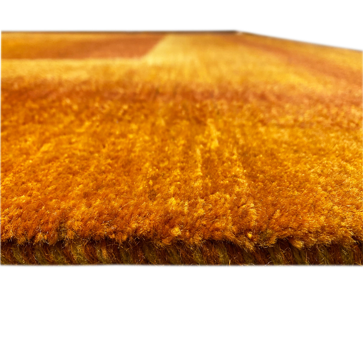 Carpet detail: dense pile in golden brown with a darker central area