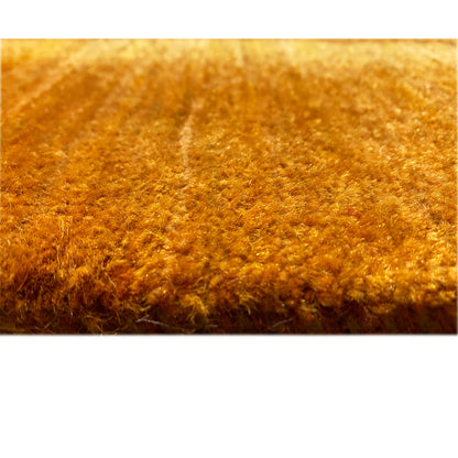 Carpet pile, appearing dense and soft, in a honey-brown color