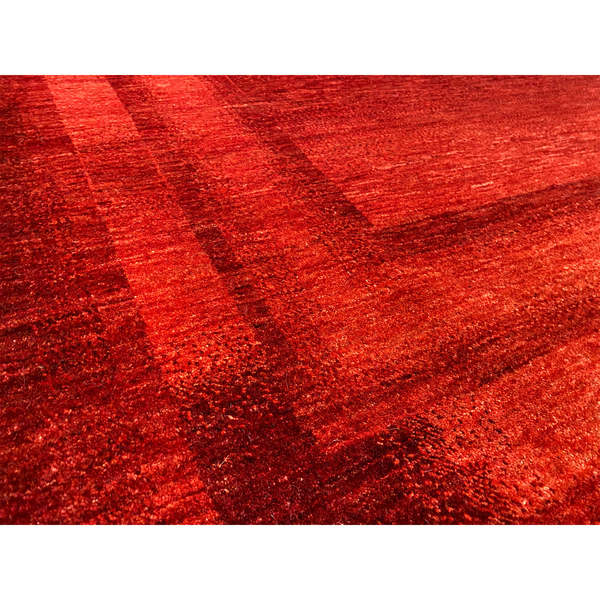 Close-up: red Gabbeh-Luri rug with a textured surface and block pattern