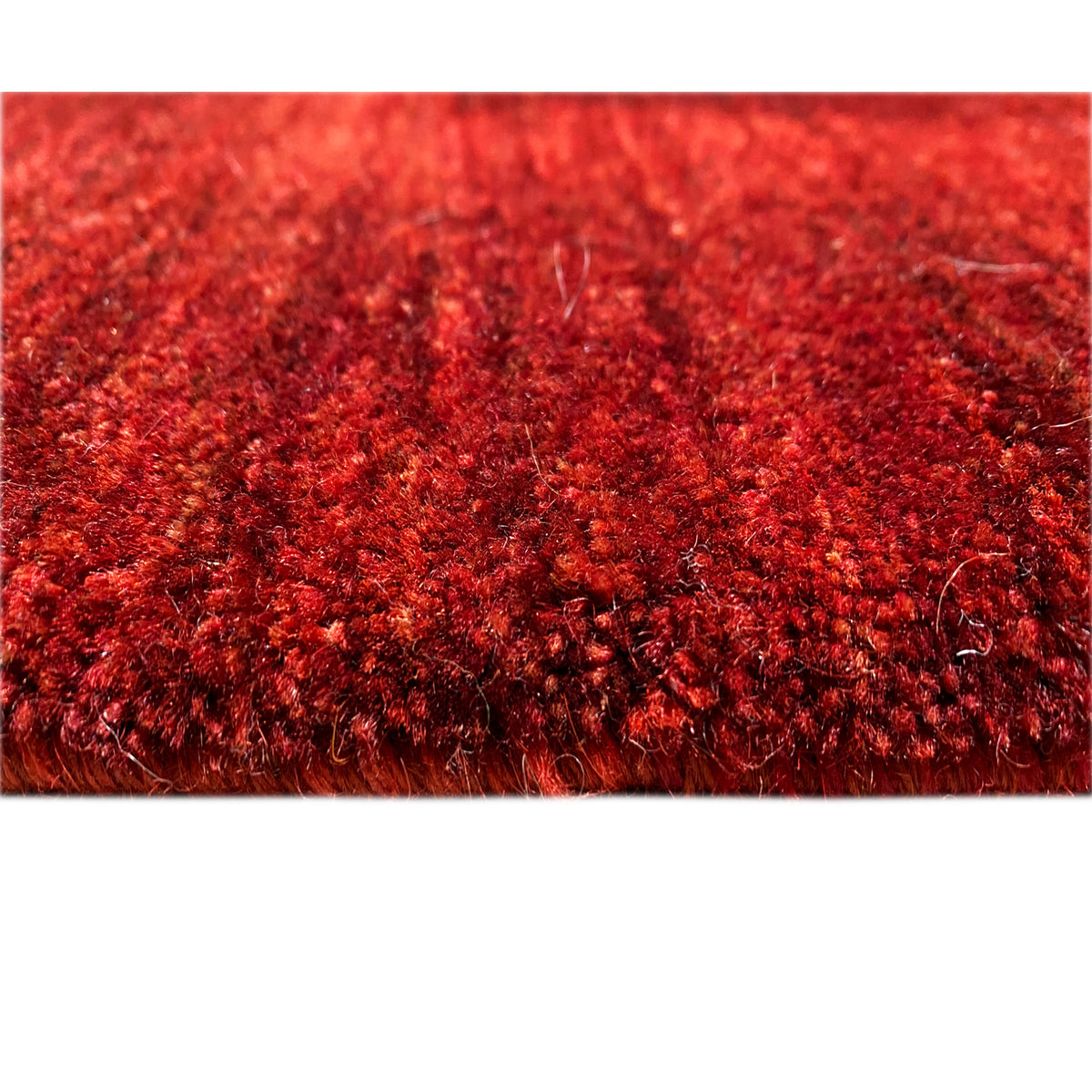 Close-up of the pile: red Gabbeh-Luri rug with a dense, glossy fiber surface