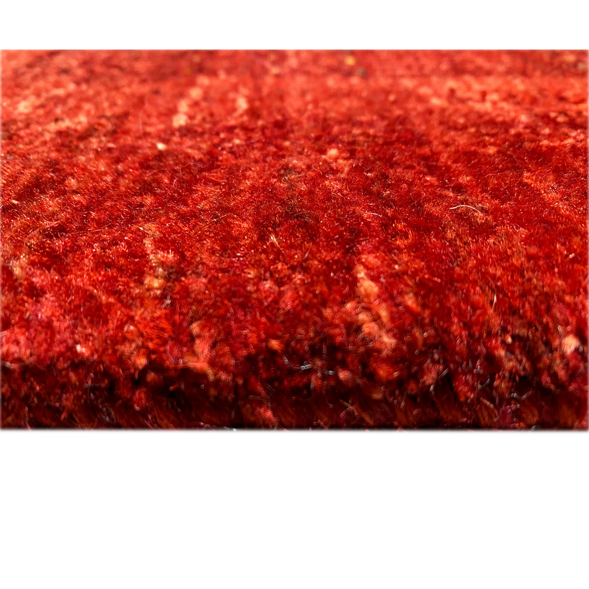 Red Gabbeh-Luri rug, close-up of the pile surface with a fine, dense weave structure