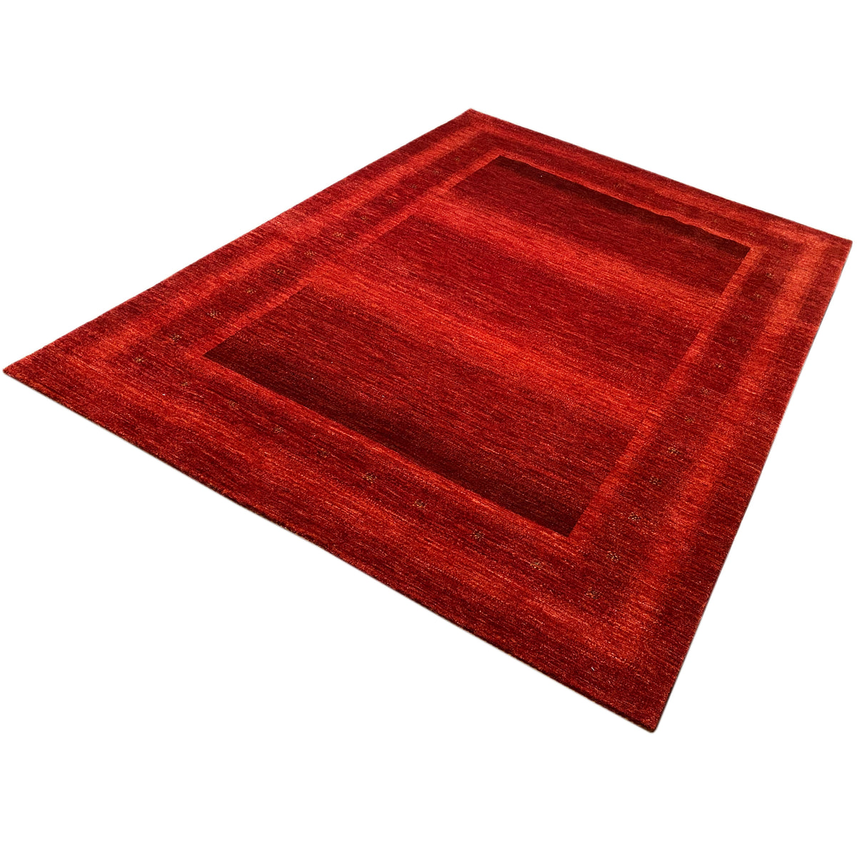 Gabbeh-Luri rug in red, angled with a rectangular central motif
