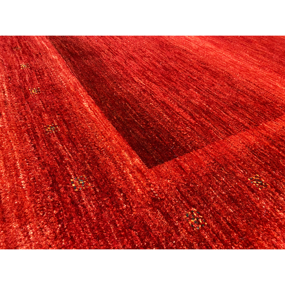 Gabbeh-Luri rug in red in detail: patterned texture with glossy accents