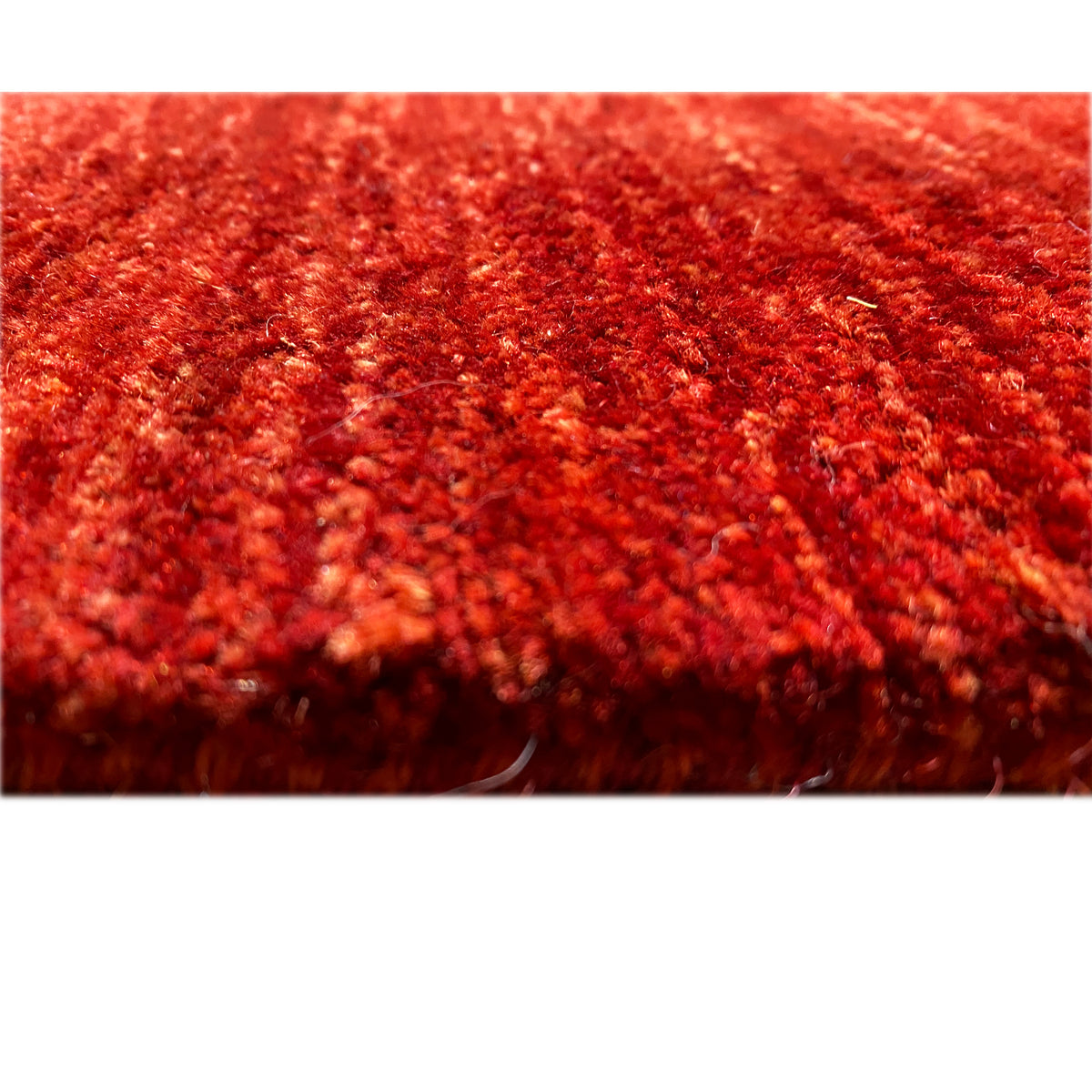 Gabbeh-Luri rug in red, close-up of the pile texture and shiny fibers