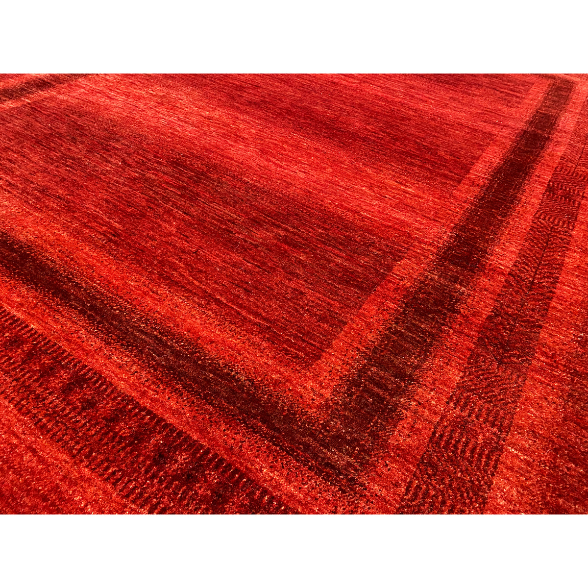 Close-up: red carpet fabric with a subtle shimmer and lines in the center