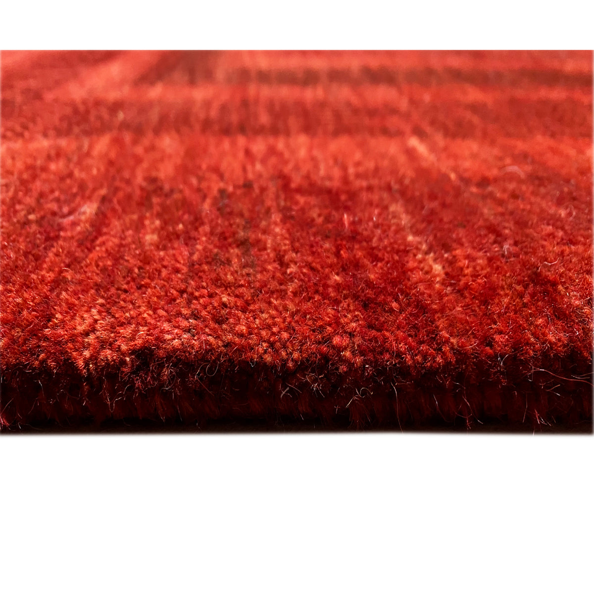 Rug underside with dense pile and an even red color tone
