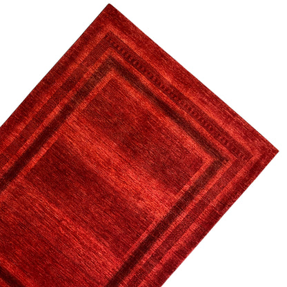 Red carpet with a square pattern and several narrow decorative stripes