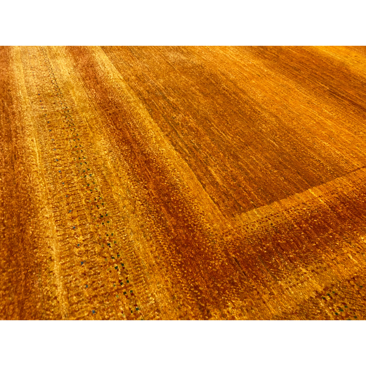 Close-up: orange-brown carpet fabric with a fine, dense weave pattern