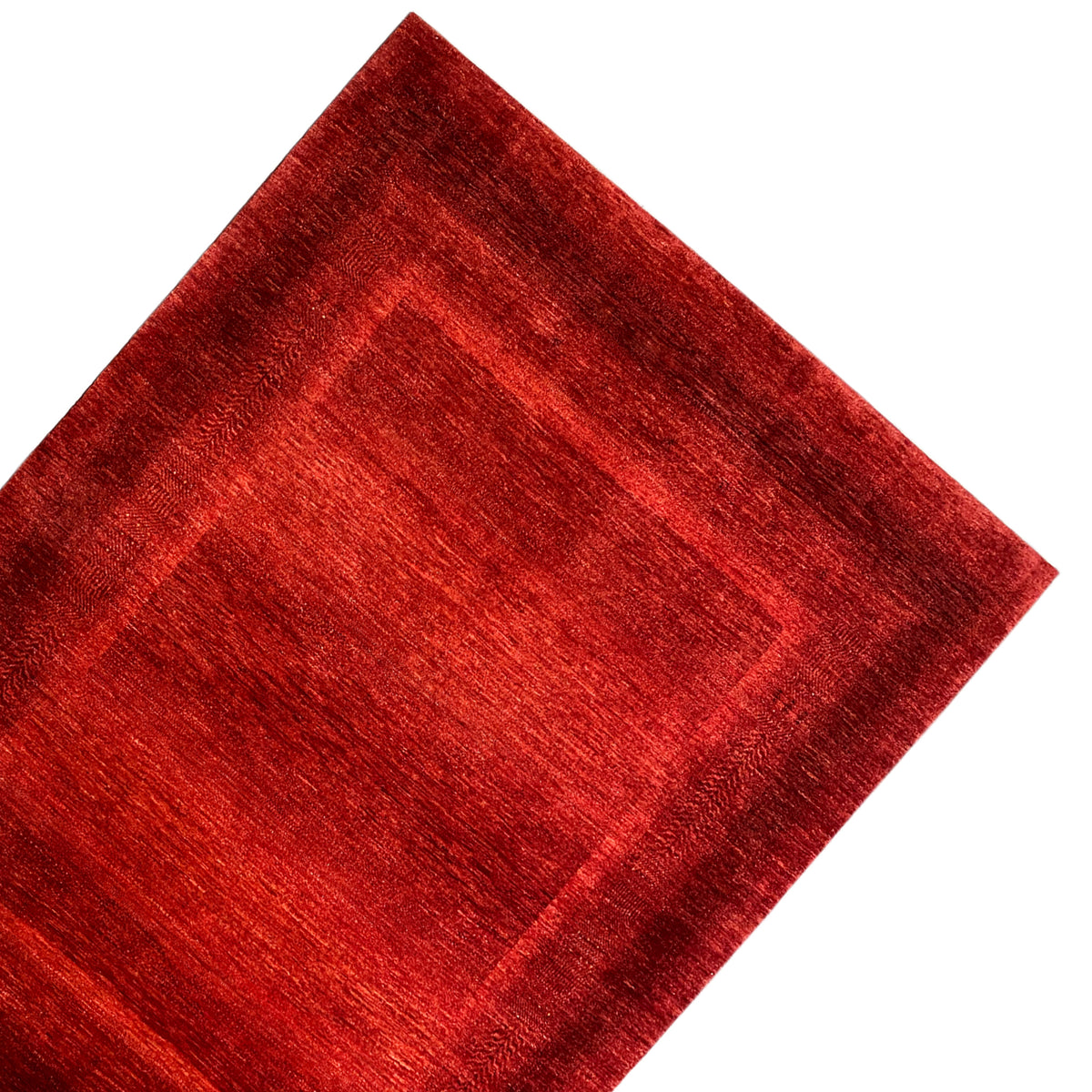 Red carpet made of textured wool with a linear border pattern