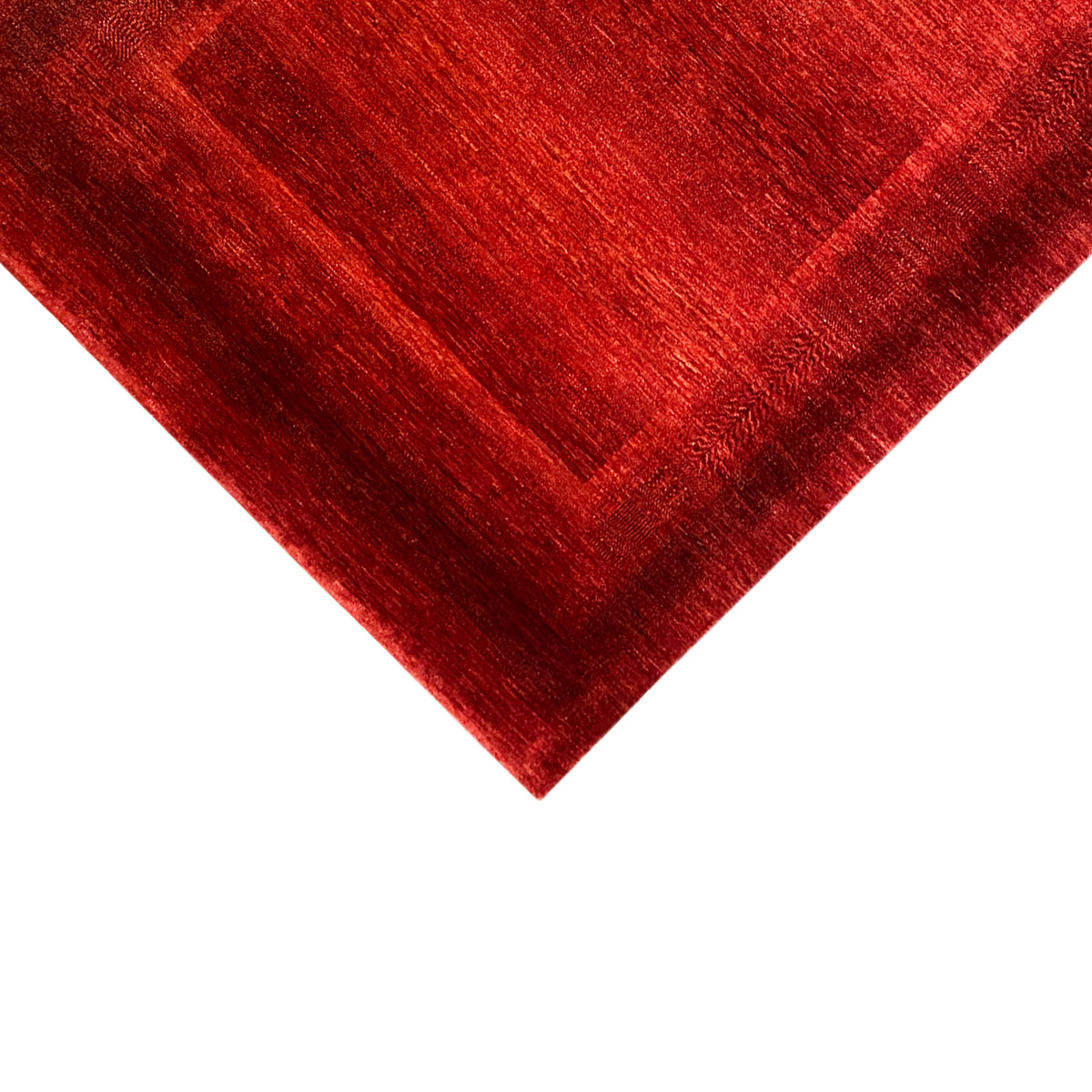Red carpet with crisp patterned edges and a fine, mottled pile texture
