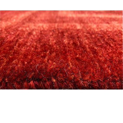 Close-up of carpet pile with a dense reddish-brown fiber texture at the edge