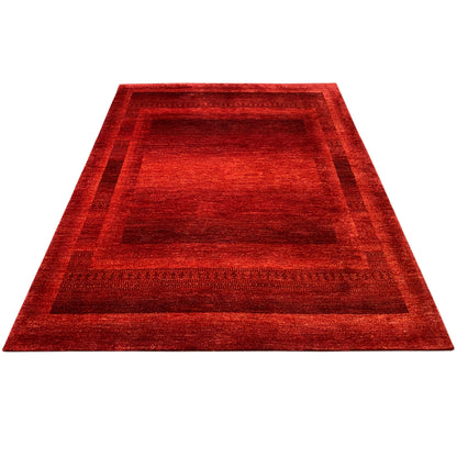 Gabbeh Luri rug, red field pattern with border, viewed from an oblique angle