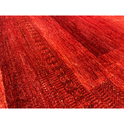 Close-up of a Gabbeh-Luri rug: shimmering red surface with a linear texture