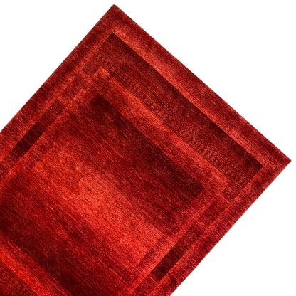 Gabbeh-Luri carpet detail: red rectangular field with dark stripes in the border