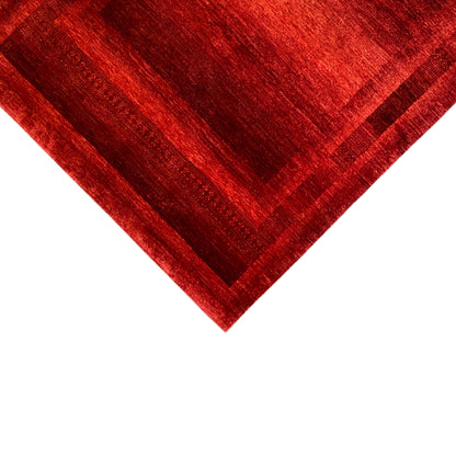 Gabbeh-Luri rug detail: diagonal striped pattern in red with a bordered corner