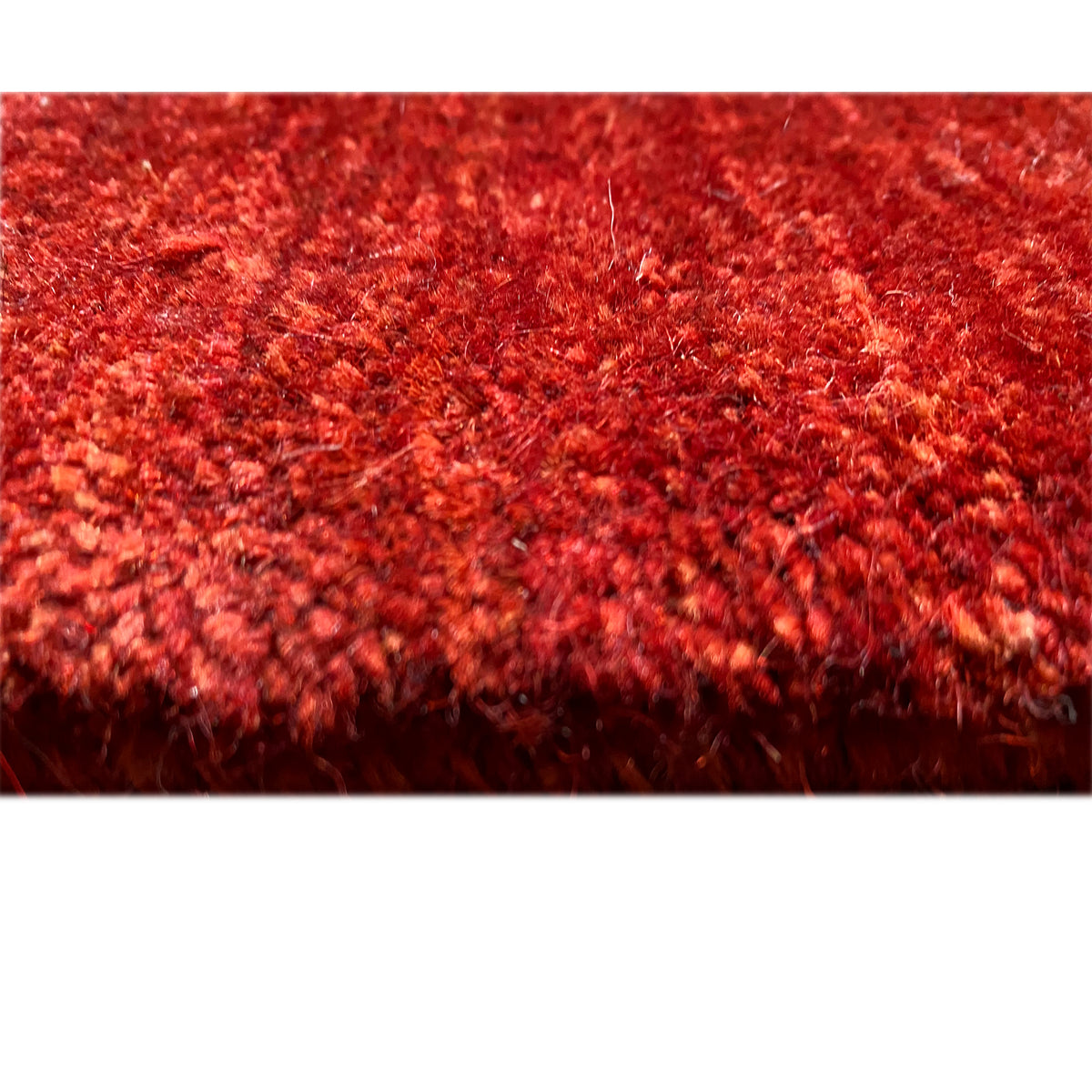Red carpet detail of the pile surface, dense, short-pile pattern